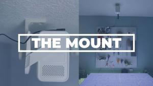 A projectors mounted using THE mount pointing at the cutting table.