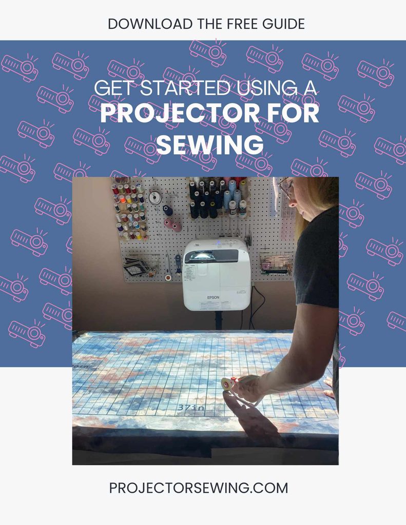a woman cutting a sewing pattern using a projector. 